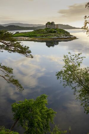 Aerial drone shot of Castle Tioram, it is a ruined castle that sits on the tidal island Eilean Tioram in Loch Moidart, Lochaber, Highland, Scotland. It is located west of Acharacle.のeditorial素材