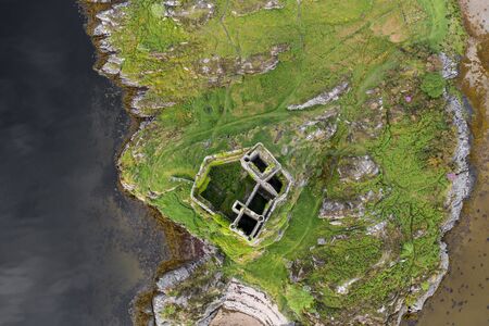 Aerial drone shot of Castle Tioram, it is a ruined castle that sits on the tidal island Eilean Tioram in Loch Moidart, Lochaber, Highland, Scotland. It is located west of Acharacle.の写真素材