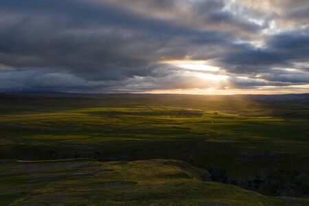 Sunrays dance across above Gordale Scar, Malham, in the Yorkshire Dales National Parkの写真素材