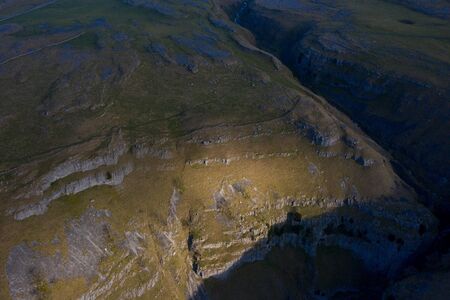 Gordale Scar is a limestone ravine 1 mile northeast of Malham, North Yorkshire, England. It contains two waterfalls and has overhanging limestone cliffs over 100 metres highの写真素材