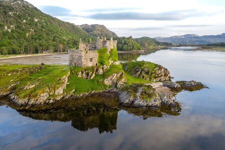 Aerial drone shot of Castle Tioram, it is a ruined castle that sits on the tidal island Eilean Tioram in Loch Moidart, Lochaber, Highland, Scotland. It is located west of Acharacle.の写真素材