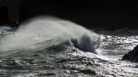 Waves crash on to the rocks and beaches of a cornish coastline, UKの写真素材