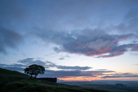 An aerial Sunrise drone shot of Top Withens or Top Withins, this farmhouse has been associated withの写真素材