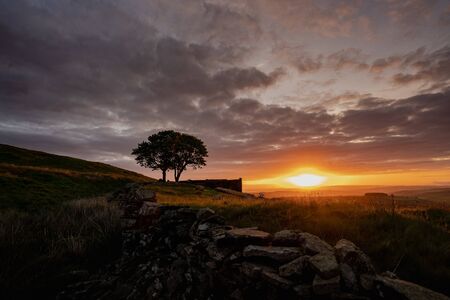 An aerial Sunrise drone shot of Top Withens or Top Withins, this farmhouse has been associated withの写真素材