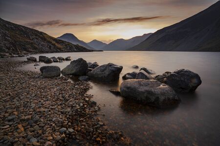 Sunrise over Wast Water a lake located in Wasdale, a valley in the western part of the Lake District National Park, England, it is the deepest lake in England at 258 feetの写真素材