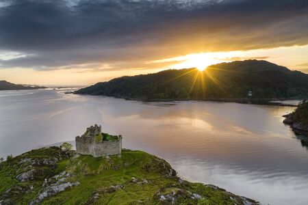 Aerial drone shot of Castle Tioram, it is a ruined castle that sits on the tidal island Eilean Tioram in Loch Moidart, Lochaber, Highland, Scotland. It is located west of Acharacle.の写真素材