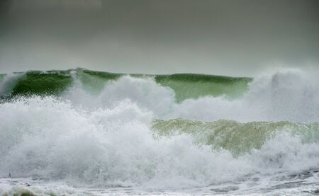 Waves crash on to the rocks and beaches of a cornish coastline, UKの写真素材