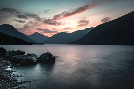 Sunrise over Wast Water a lake located in Wasdale, a valley in the western part of the Lake District National Park, England, it is the deepest lake in England at 258 feetの写真素材