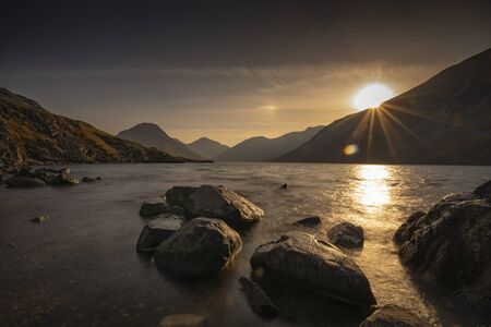 Sunrise over Wast Water a lake located in Wasdale, a valley in the western part of the Lake District National Park, England, it is the deepest lake in England at 258 feetの写真素材