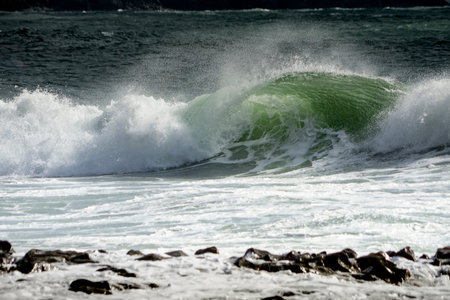 Waves crash on to the rocks and beaches of a cornish coastline, UK