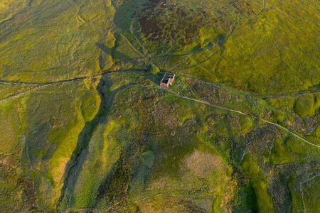 An aerial Sunrise drone shot of Top Withens or Top Withins, this farmhouse has been associated with "Wuthering Heights".の写真素材