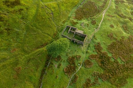 An aerial Sunrise drone shot of Top Withens or Top Withins, this farmhouse has been associated with "Wuthering Heights".の写真素材
