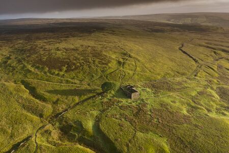 An aerial Sunrise drone shot of Top Withens or Top Withins, this farmhouse has been associated with "Wuthering Heights".の写真素材
