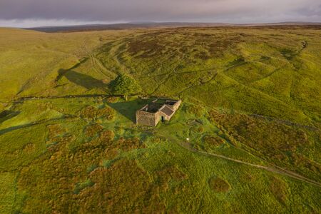 An aerial Sunrise drone shot of Top Withens or Top Withins, this farmhouse has been associated with "Wuthering Heights".の写真素材