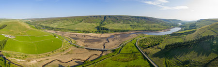 Aerial view of a dramatically low Woodhead Reservoir during drought conditions, The reservoir, part of a system supplying drinking water to Greater Manchester, lies in North Derbyshire, June 2025の写真素材
