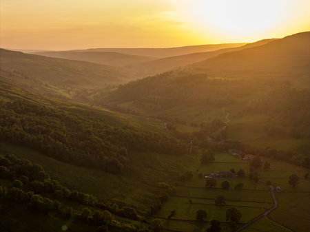Stunning Aerial View Buckden Villagesurronding fields in the Yorkshire Dales Bathed in Evening Sunlightの写真素材