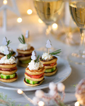 Christmas tree canape with cucumber slice, salmon pate and red caviar for festive xmas snack. Verticalの写真素材