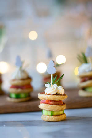 Christmas tree canape with cucumber slice, salmon pate and red caviar for festive xmas snack. Verticalの写真素材