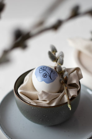 One painted easter egg on the plate. Still life easter concept. Vertical