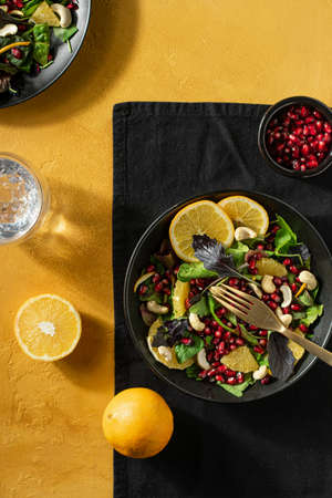 Fresh salad with orange and pomegranate seeds, Verticalの写真素材