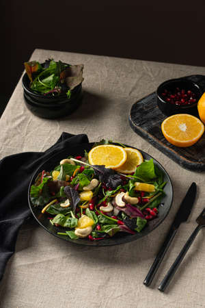 Fresh salad with orange and pomegranate seeds, spinach. Detox salad. Vegan conceptの写真素材
