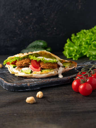 Shawarma sandwich falafel. Traditional Eastern snack. wooden background.の写真素材