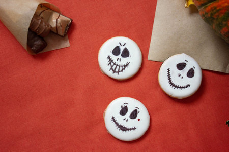 sugar round cookies in white glaze with a scary face, decoration for the holiday Halloween