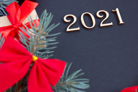 new year decorations with inscription 2021 from wooden numbers on dark background