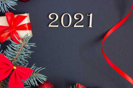 new year decorations with inscription 2021 from wooden numbers on dark background