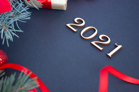 stylish new year with red shades, 2021 wooden numbers on dark background