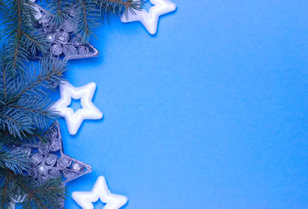christmas background with stars on a blue background with fir branches, delicate christmas cardの写真素材