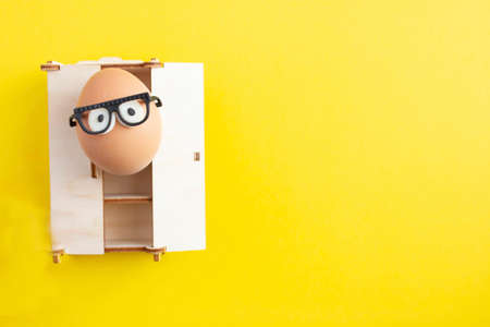 creative eggs for easter on yellow background, crazy outfitの写真素材