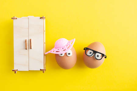 creative eggs for easter on yellow background, crazy outfitの写真素材