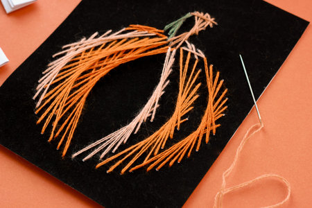 original card with orange threads for Halloween, pumpkin embroidered with cotton threads autumn...