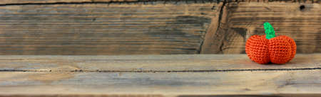 knitted orange pumpkin on wooden background, space for text, autumn sale.の写真素材