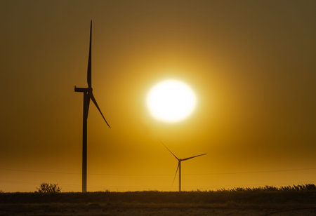 wind generators on the background of the sky without clouds at sunset near the Lemurian lake,...