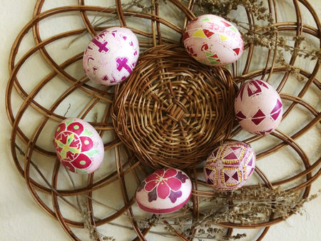 very beautiful painted Easter eggs for celebrating Easter are placed on wicker platter