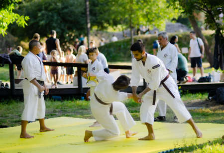 Outdoor training of judo children in white kimonos