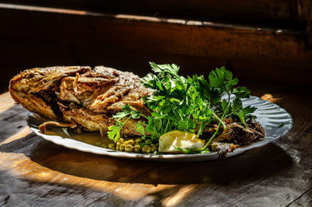 fried fish on a plate with herbs and green peas looks very appetizing without people