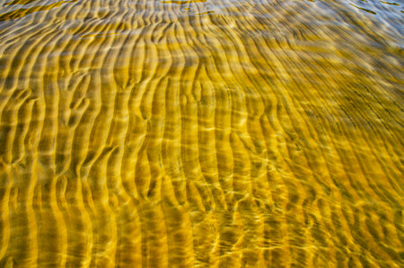 great background whimsical patterns on the sand across the water horizontal orientation good for photo wallpaperの写真素材