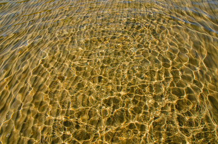 great background whimsical patterns on the sand across the water horizontal orientation good for photo wallpaperの写真素材