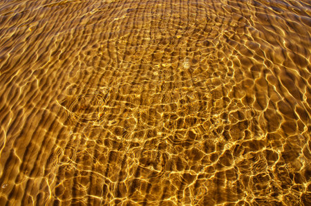 great background whimsical patterns on the sand across the water horizontal orientation good for photo wallpaperの写真素材