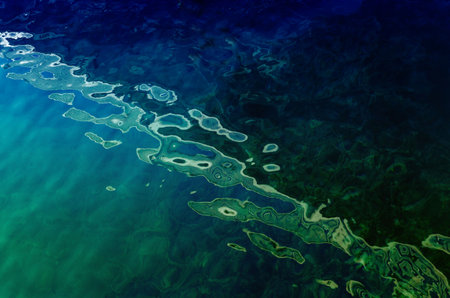 water surface making multiple water circles against blue background beauty product background, water-based concept.の写真素材