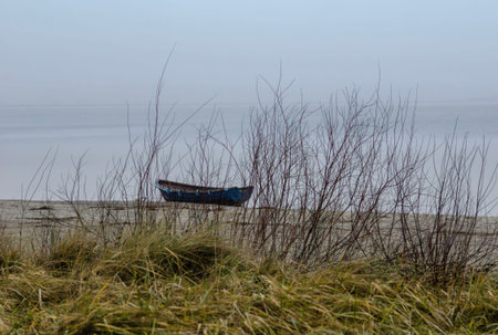 Poland Gdynia January 1, 2024 boat on the seashore in the fog.の写真素材