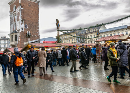 Winter Christmas market in European city with festive decorations and people buying gifts and souvenirs at the fairのeditorial素材