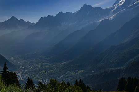 Sunny summer view of Mont Blanc massif with green alpine meadows and forest in French Alpsの写真素材