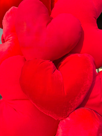 Close-up of soft red plush hearts creating romantic Valentines Day background for love and passion concepts.の写真素材