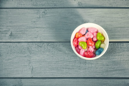 Colored pills in a round dish.