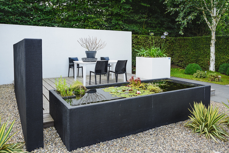 Appeltern, The Netherlands, July 22, 2015: The Gardens of Appeltern is the inspiration garden park in the Netherlands. In this picture a garden with modern garden furniture and trendy pond.のeditorial素材
