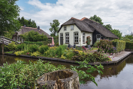 Giethoorn, Netherlands - June 29, 2016: known for its bridges, waterways, thatched cottages  and punters. It is also called the 'Dutch Venice' and known to the world Monopoly edition.のeditorial素材